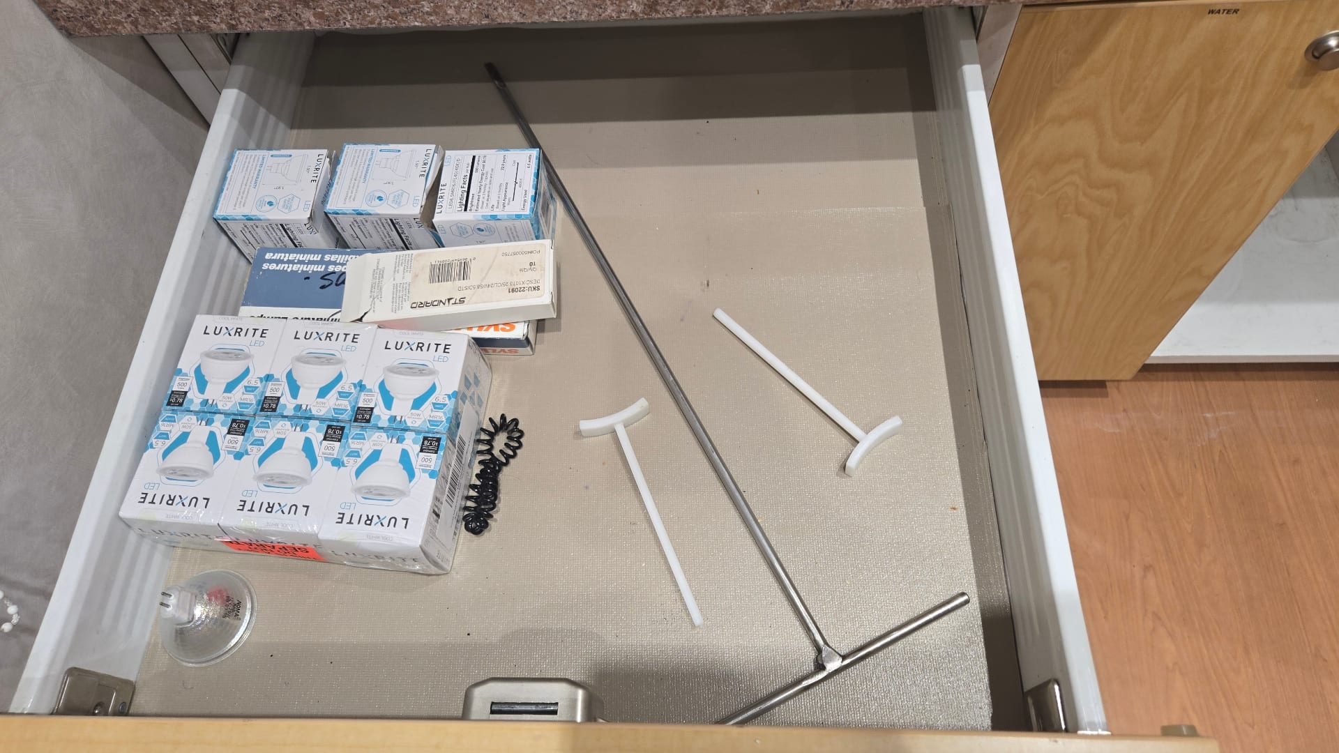 Mobile medical trailer interior — exam room with clinical cabinetry and sink
